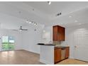 Open-concept living space with hardwood floors, recessed lighting, and a balcony, adjacent to a kitchen area at 1075 Peachtree Ne Walk # A421, Atlanta, GA 30309