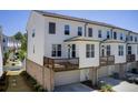 Rear view of a townhome featuring an elevated deck and garage at 1263 Harvest Park Ln, Suwanee, GA 30024