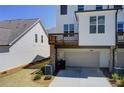 Townhome garage and elevated deck with a well maintained lawn at 1263 Harvest Park Ln, Suwanee, GA 30024