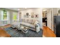 Inviting living room with a comfortable sectional and hardwood floors at 298 Birch St, Atlanta, GA 30354