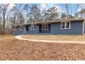 Single-story home with a brick facade, complemented by large windows and a landscaped yard at 4145 White Oak Dr, Winston, GA 30187