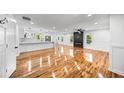 Bright, open-concept living area with hardwood floors and modern fireplace, flowing seamlessly into the kitchen at 2798 Hutchins Rd, Lawrenceville, GA 30044