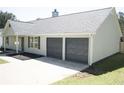 Home's garage featuring two doors for convenience at 6737 Mason Creek Rd, Douglasville, GA 30135