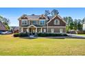 Charming two-story home with a well-maintained lawn and a classic design at 1041 Sweetwater Bridge Cir, Douglasville, GA 30134