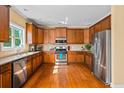 Well-equipped kitchen with stainless steel appliances and beautiful hardwood floors at 1041 Sweetwater Bridge Cir, Douglasville, GA 30134