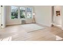 Bright and airy living room with large windows, light hardwood flooring, and simple decor at 301 10Th Ne St # 3, Atlanta, GA 30309
