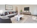 A staged living room featuring a sofa, decorative pillows, and modern furnishings at 301 10Th Ne St # 3, Atlanta, GA 30309