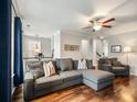 Cozy living room featuring a sectional couch, hardwood floors, and a ceiling fan at 3501 Chattahoochee Summit Se Ln, Atlanta, GA 30339