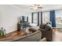 Bright living room with hardwood floors, blue curtains and an entertainment center at 3501 Chattahoochee Summit Se Ln, Atlanta, GA 30339