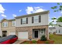 A well-kept two-story home featuring an attached garage and neatly landscaped front yard at 3541 Condor Ct, Atlanta, GA 30331