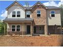 New construction featuring a brick and siding facade, open garage, and covered porch at 1594 Sungrown Way, Mcdonough, GA 30253