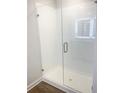 Modern bathroom with a subway tiled shower featuring a clear glass door and brushed nickel hardware at 1594 Sungrown Way, Mcdonough, GA 30253