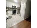 Well-lit kitchen featuring white cabinets, stainless steel appliances, and a tiled backsplash, ideal for cooking at 705 Windchase Ln, Stone Mountain, GA 30083