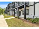 Charming townhome exteriors with black trim, balconies, and well-maintained lawns at 823 Mackay Crk, Woodstock, GA 30188