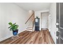 Inviting foyer with wood-look floors, staircase, and natural light at 823 Mackay Crk, Woodstock, GA 30188