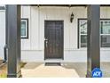 Classic black front door framed by sidelight windows and black columns at 823 Mackay Crk, Woodstock, GA 30188
