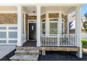Inviting front porch showcasing stone accents, a bay window, and a stylish front door at 1159 Thornwell Ne Dr, Brookhaven, GA 30319