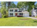 Charming two-story home with a well-maintained lawn, a red front door and lush landscaping at 2965 Carrie Farm Nw Rd, Kennesaw, GA 30144