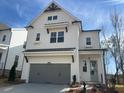 Beautiful two-story house with white siding, a gray garage door, and a well-manicured front yard at 625 Skytop Dr, Cumming, GA 30040