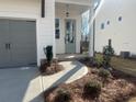 Inviting front entrance with decorative plants, a concrete walkway, and a gray-painted front door at 625 Skytop Dr, Cumming, GA 30040
