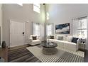 Bright living room with a soaring ceiling, modern furniture, and large windows dressed with elegant curtains at 108 Wheelers Dr, Dallas, GA 30157