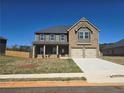 Inviting two-story home featuring a mix of brick and siding, a two-car garage, and a neatly maintained front lawn at 1636 Fuma Leaf Way, Mcdonough, GA 30253