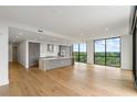 Open kitchen with an island, light colored cabinets, and large windows offering treetop views at 2425 Peachtree Ne Rd # 1409, Atlanta, GA 30305