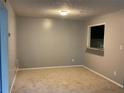 Cozy living room with neutral carpet and pass-through window to the kitchen at 2704 Cumberland Se Ct # 27, Smyrna, GA 30080