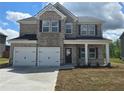 Charming two-story home with brick facade, black shutters and a two-car garage at 1613 Fuma Leaf Way, Mcdonough, GA 30253