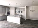 Modern kitchen featuring gray cabinets, granite countertops, and stainless steel appliances at 1613 Fuma Leaf Way, Mcdonough, GA 30253