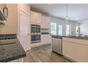 Well-equipped kitchen with stainless steel appliances, white cabinets, and granite countertops at 1613 Fuma Leaf Way, Mcdonough, GA 30253