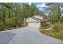 Spacious two-story home with an attached two-car garage and lush, mature landscaping at 3512 Hidden Acres Drive, Atlanta, GA 30340