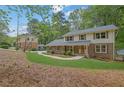 Beautiful two-story home with a brick and siding exterior surrounded by lush greenery at 3512 Hidden Acres Drive, Atlanta, GA 30340