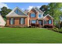 Beautiful brick two-story home with a well-manicured lawn and charming curb appeal at 6252 Fernstone Trl, Acworth, GA 30101