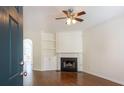 Comfortable living room with fireplace, built-in shelving, and hardwood floors at 2361 Maplewood Ct # 25, Atlanta, GA 30339