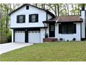 Beautifully renovated home with fresh paint, a manicured lawn, and a two-car garage at 3867 Cherie Glen Rd, Snellville, GA 30039