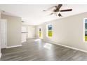 Open-concept living area with modern flooring, neutral paint, ceiling fan, and lots of natural light at 960 Revere Way, Hampton, GA 30228