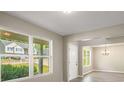 Bright living room showcasing large windows, modern paint, wood-look floors, and an open floor plan at 960 Revere Way, Hampton, GA 30228