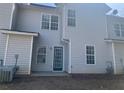 Rear exterior view showcasing the home's siding and backyard entrance at 2127 Manhattan Pkwy, Decatur, GA 30035