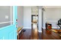 Inviting foyer featuring hardwood floors, a turquoise door, and an open view into the living spaces at 2365 Oakland Trail Way, Lawrenceville, GA 30044
