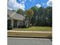 Spacious side yard features lush lawn and mature trees, creating a serene and private outdoor space at 278 Mission Oak Se Dr, Grayson, GA 30017