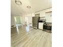 Modern kitchen with stainless steel appliances, light cabinets, and vinyl flooring at 1445 Diplomat Dr, Riverdale, GA 30296
