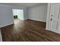Spacious living room with hardwood floors and paneled accent wall with natural light at 173 Amherst Nw Pl, Atlanta, GA 30327