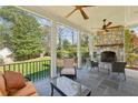 Relaxing covered porch featuring a stone fireplace, ceiling fans, and outdoor seating at 3114 Peachtree Ne Dr, Atlanta, GA 30305