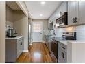 Beautiful renovated kitchen featuring stainless steel appliances, modern cabinets and hardwood floor at 1021 Magnolia Se Dr, Smyrna, GA 30082