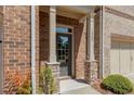 A close up view of the front entry way with a gray front door, a stone base, and the house number at 1983 Silver Birch Se Dr, Smyrna, GA 30080