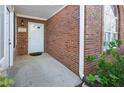 A brick front porch with a white door and trim, showing well-kept landscaping and a welcoming entrance at 3858 Vineyards Lake Nw Cir # U-19, Kennesaw, GA 30144