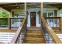 Close-up of the home's entry with a covered front porch and wooden steps at 505 Cedar Creek Nw Rd, Cartersville, GA 30121