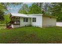 View of home's rear exterior, showcasing the well-maintained lawn at 505 Cedar Creek Nw Rd, Cartersville, GA 30121
