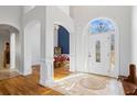 Bright foyer with elegant tile flooring, soaring ceilings, and an arched doorway leading to the dining room at 135 Antoinette Ave, Mcdonough, GA 30252